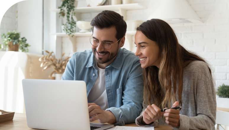 Happy duo using a computer